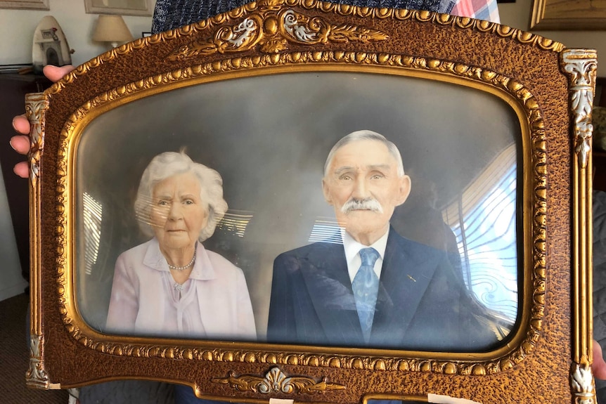 The old gold gilt framed portrait of Tom and Amelia Jones.
