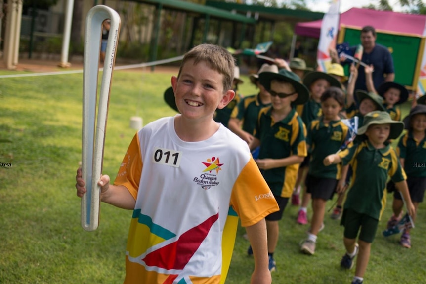 An 11-year-old boy carries the Queen's Baton ahead of the Commonwealth Games on the Gold Coast