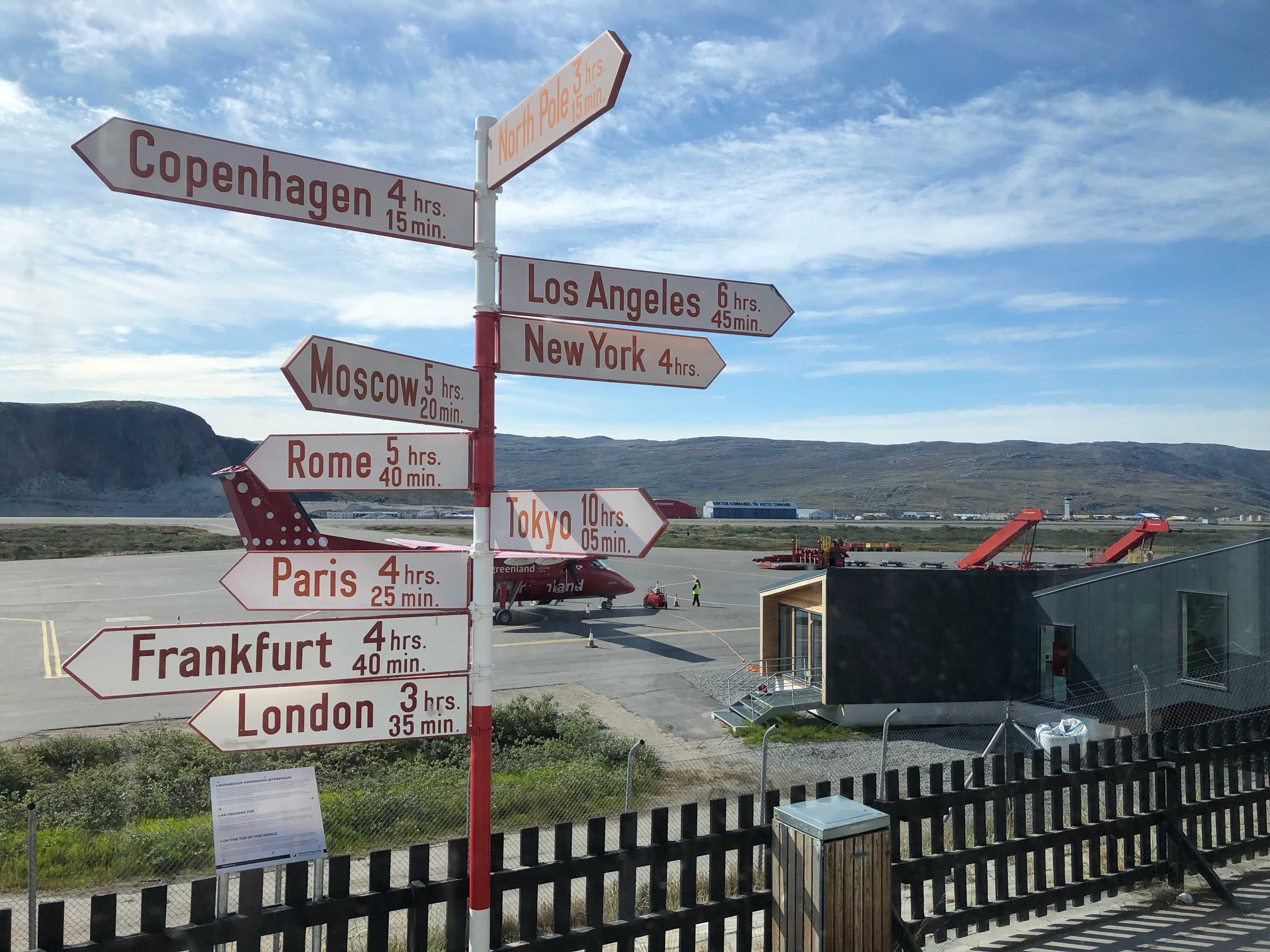 Kangerlussuaq Airport in Greenland show how far it is to other parts of the world.