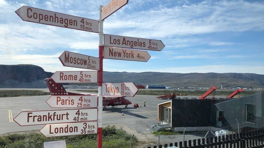 Kangerlussuaq Airport in Greenland show how far it is to other parts of the world.
