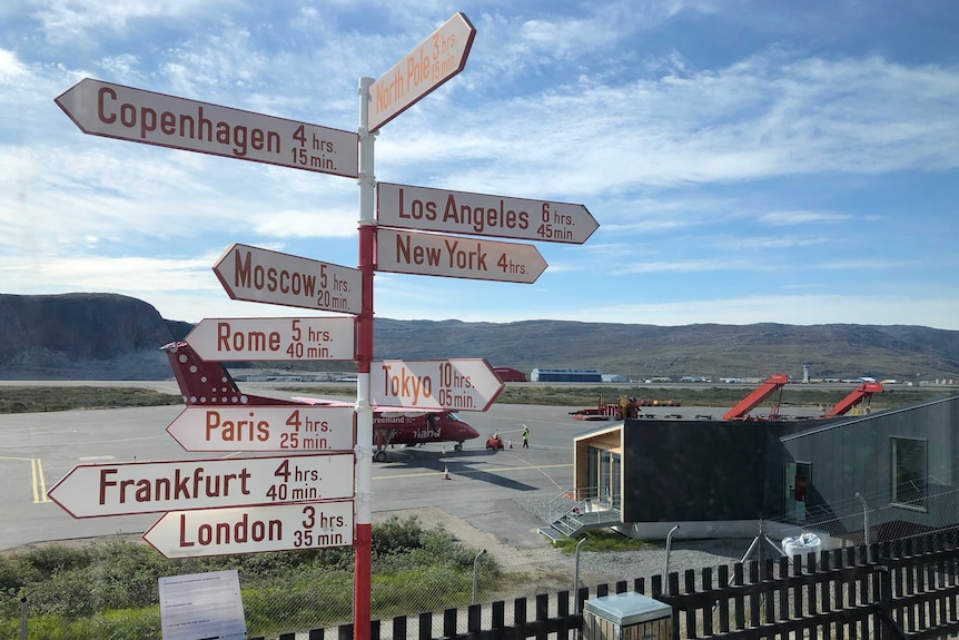 Kangerlussuaq Airport in Greenland show how far it is to other parts of the world.