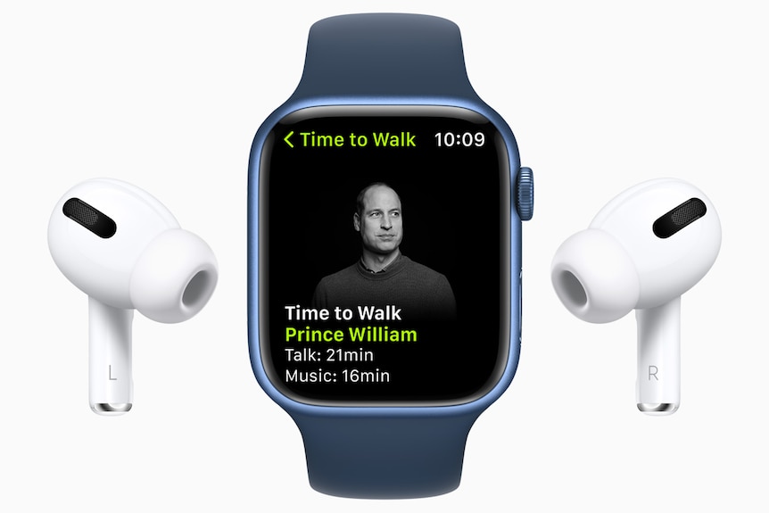 A smart watch with a picture of Prince William on the screen, with an ear bud on either side. 