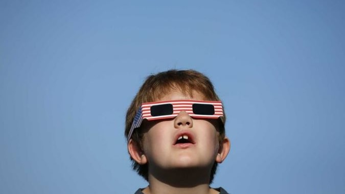 Boy with eclipse glasses