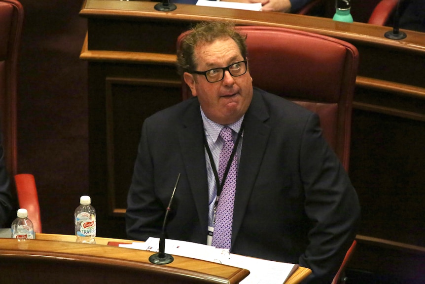 A mid-shot of Ben Dawkins sitting in WA's Legislative Council looking up to his left.