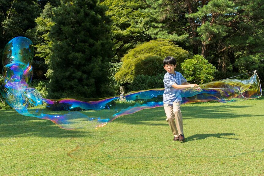 Japan's Prince Hisahito creating giant bubbles