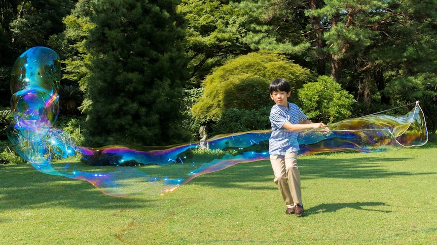 Japan's Prince Hisahito creating giant bubbles
