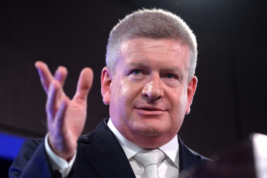 Senator Mitch Fifield shows off a set of his cufflinks