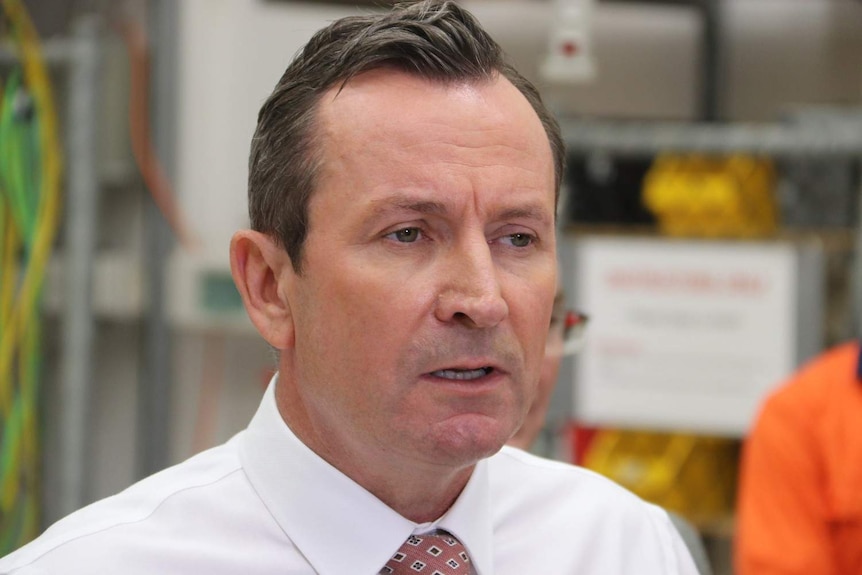 Mark McGowan wears a white shirt and dark pink tie, looking concerned.