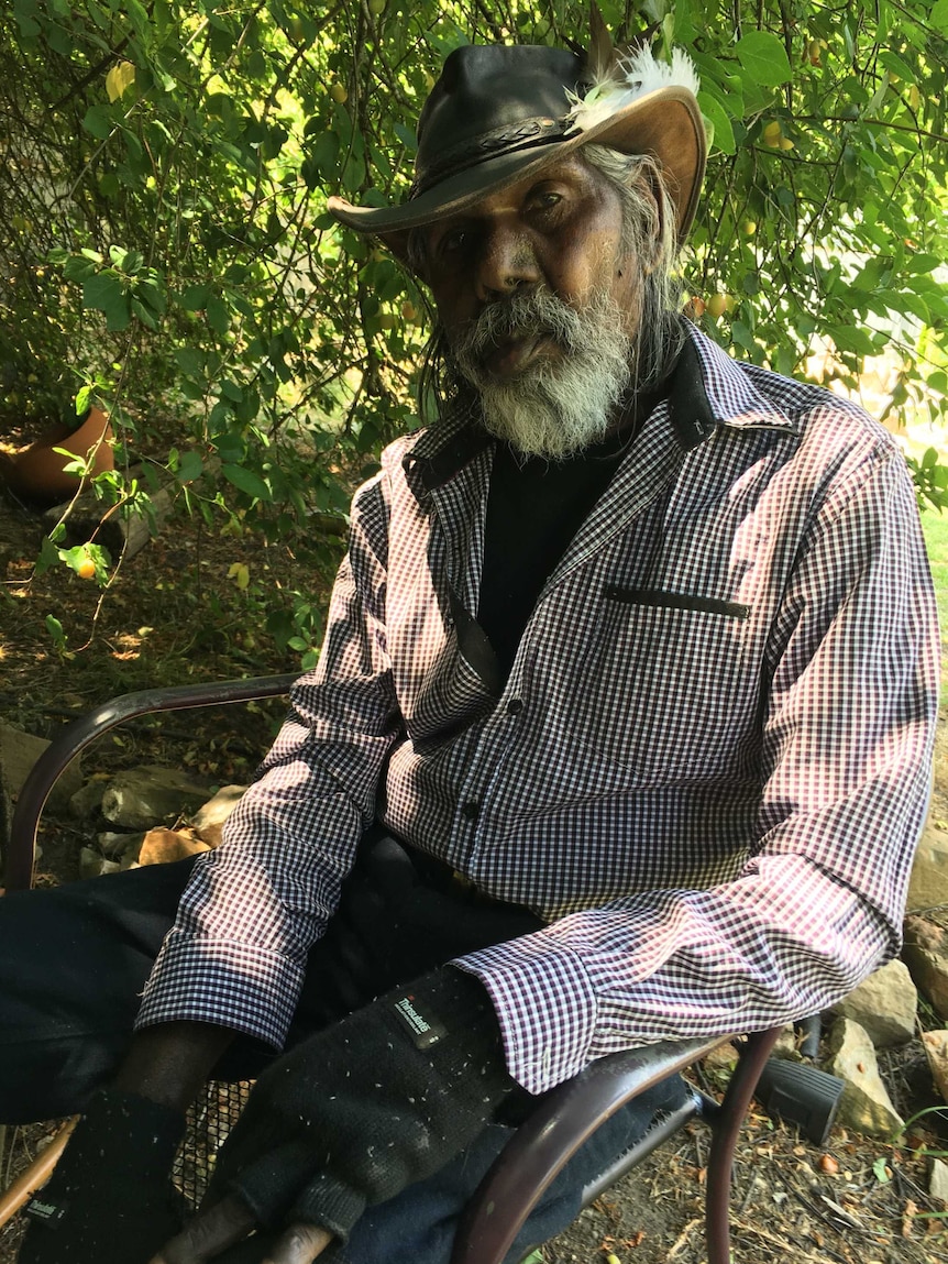 Actor David Gulpilil sitting in a chair.