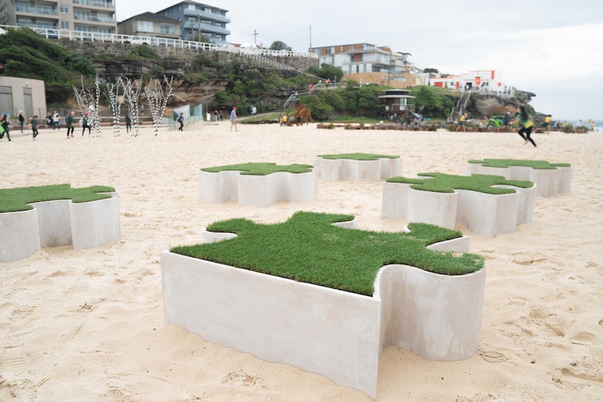 Sculpture “Turf Wars” by Anne Levitch features a set of 7 astroturfed puzzle pieces.