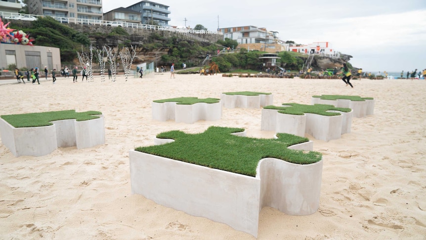 Sculpture “Turf Wars” by Anne Levitch features a set of 7 astroturfed puzzle pieces.