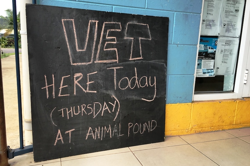 A message on a blackboard outside the community store advises the vet is in town