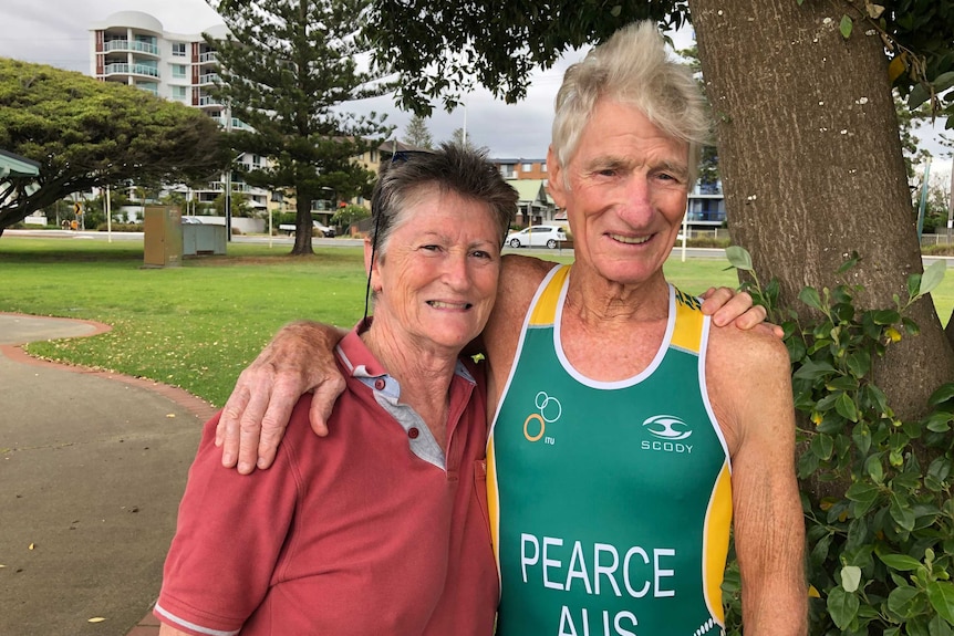 Keith Pearce standing with his arm around his wife.