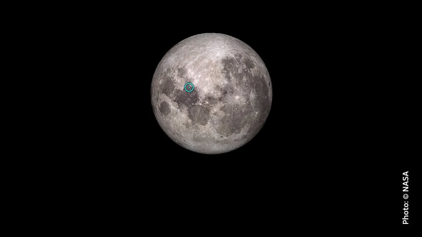 Image of moon with blue highlight marking Apollo 11 landing site