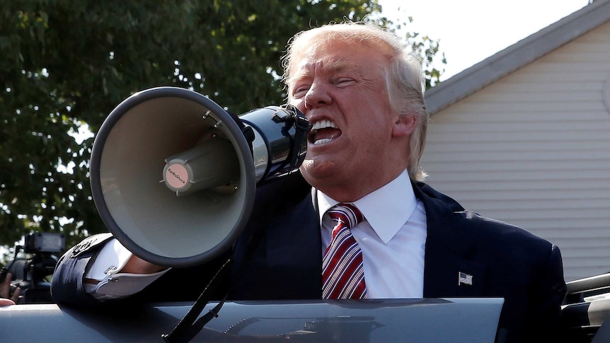 Republican presidential nominee Donald Trump speaks to supports through a megaphone during campaign in Ohio.