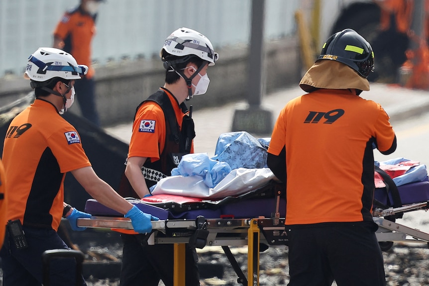 An emergency worker in an orange uniform.