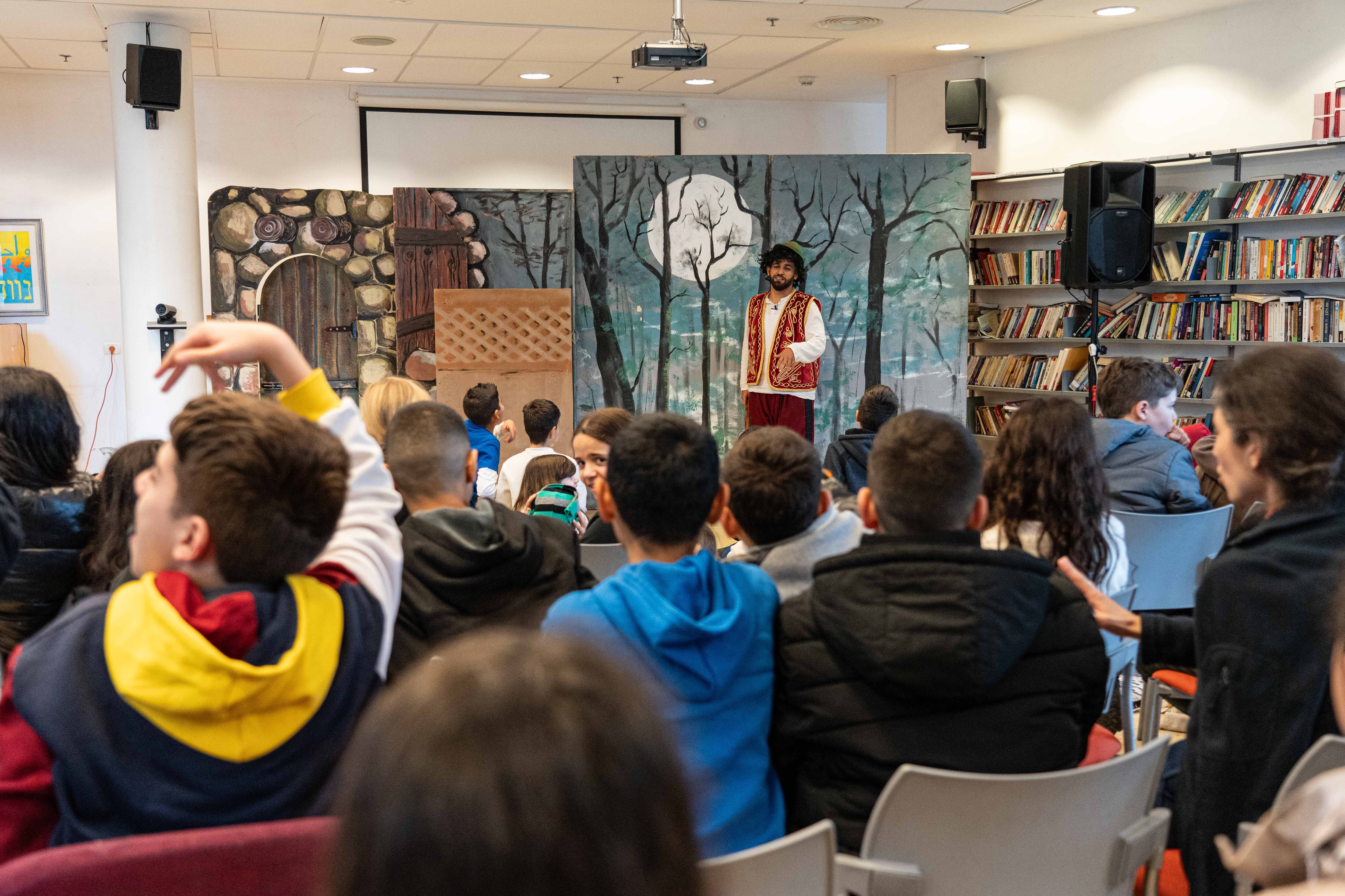 A Palestinian actor performs a comedic play in front of the children from the Oasis of Peace school.