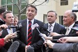 Rob Oakeshott and Tony Windsor stand with Christopher Pyne and Anthony Albanese