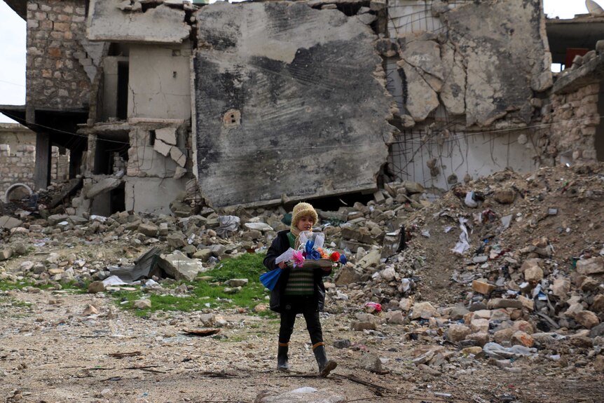 Syrian girl sells roses in war-torn Aleppo