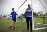 Shellharbour Junior Football Club president Yani Sekuloski with his son James at a soccer field.