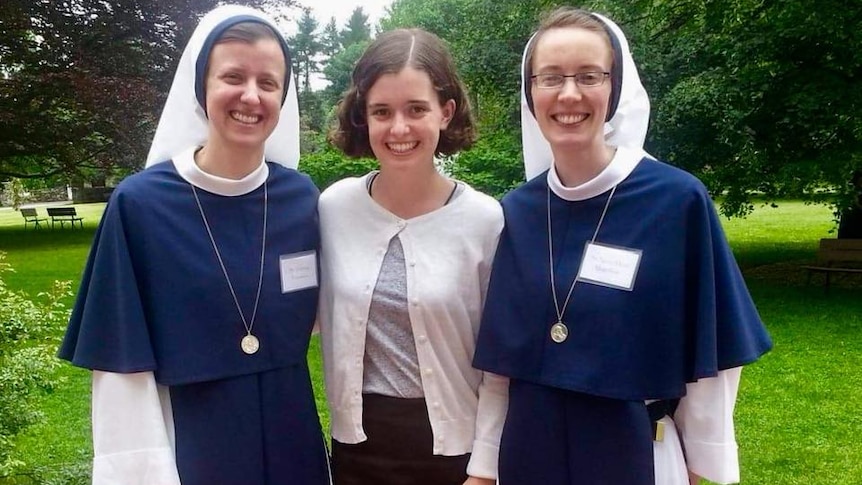 Nancy Webb stands with two smiling nuns from the Sisters of Life convent in New York.