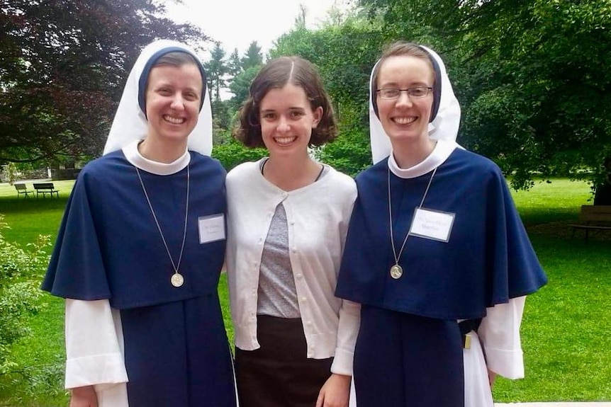 Nancy Webb stands with two smiling nuns from the Sisters of Life convent in New York.