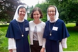 Nancy Webb stands with two smiling nuns from the Sisters of Life convent in New York.