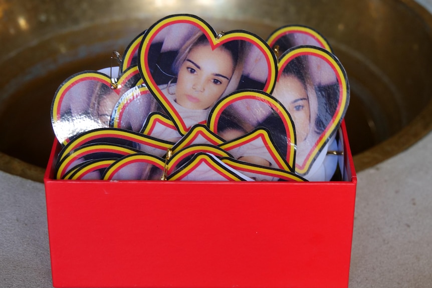 A box of heart shaped badges in a small box.