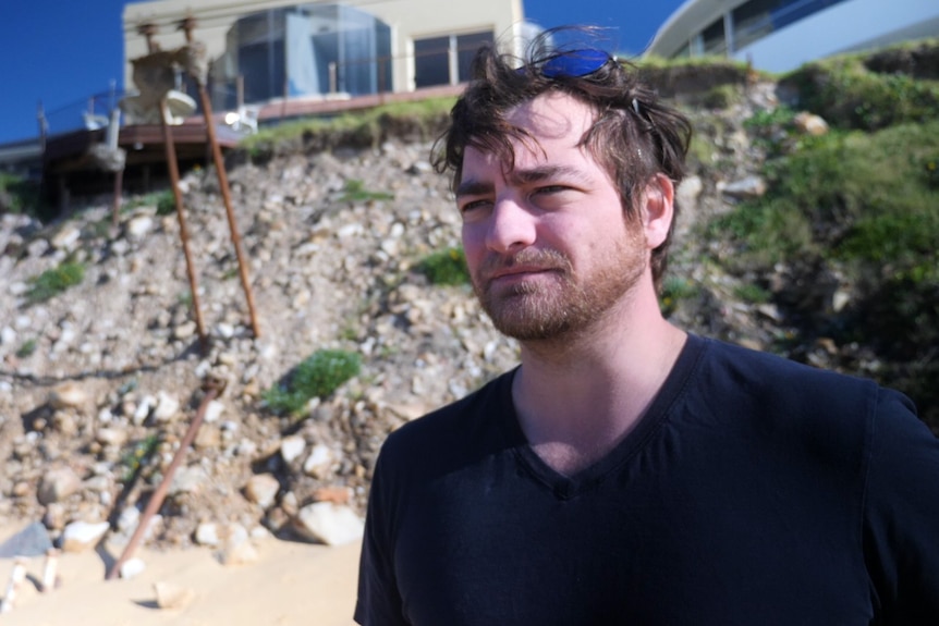 Man stands infront of his erosion prone home