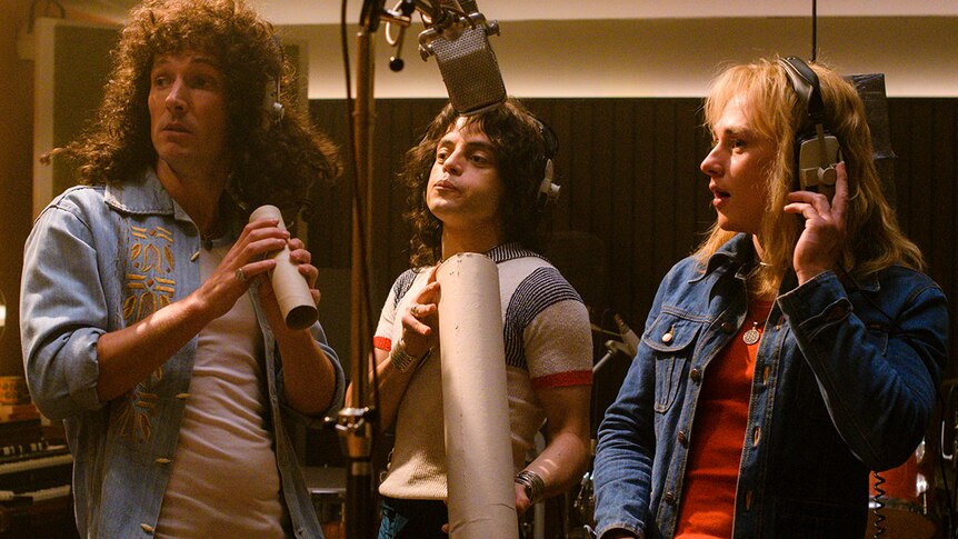 Colour still of Gwilym Lee, Rami Malek and Ben Hardy in recording studio in 2018 film Bohemian Rhapsody.