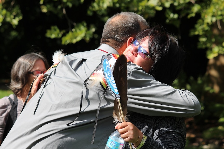 Dennis White Eye embraces Denise General.