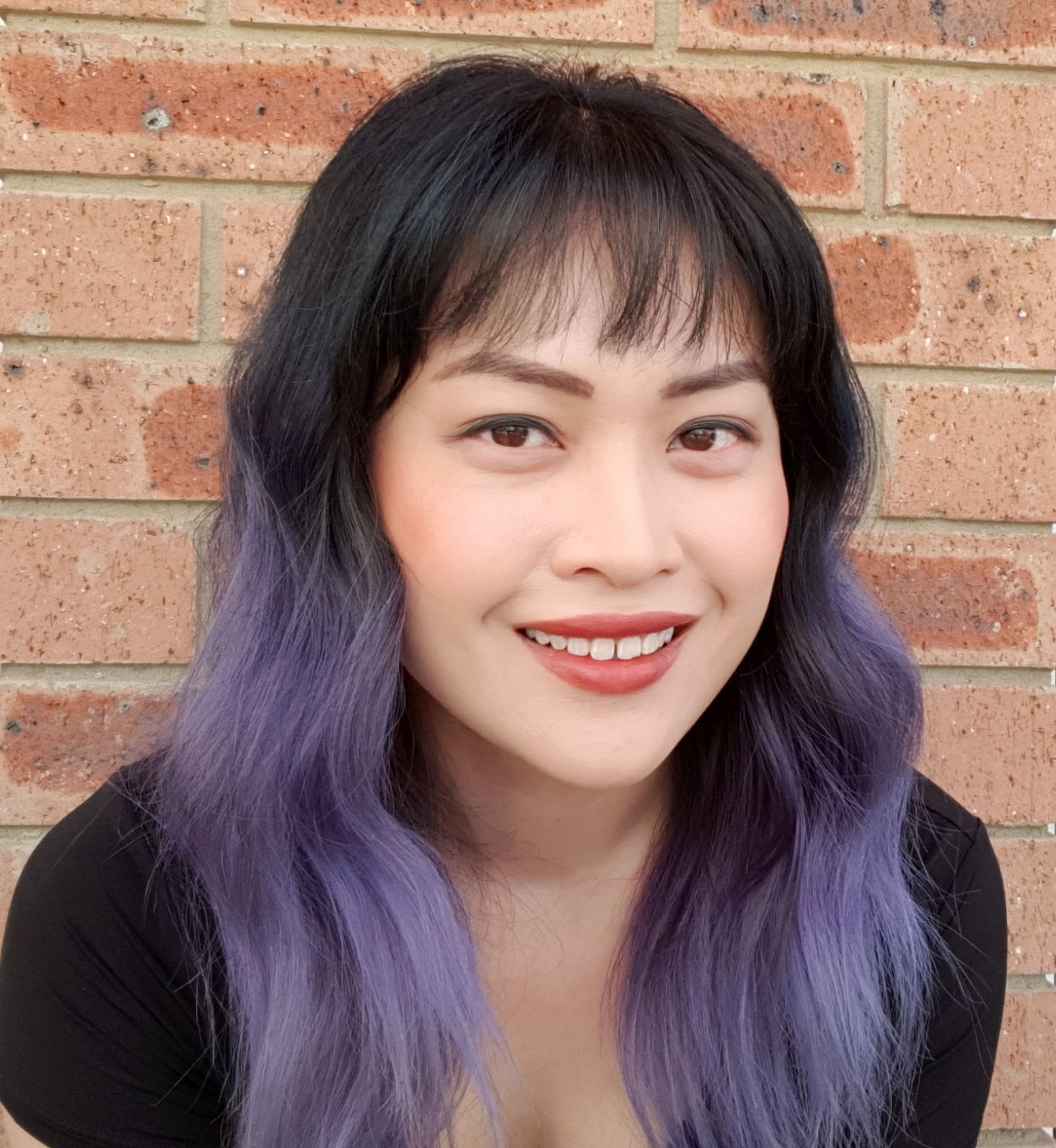 Dr Michelle Wong smiling in a portrait photo.
