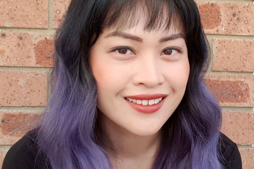 Dr Michelle Wong smiling in a portrait photo.