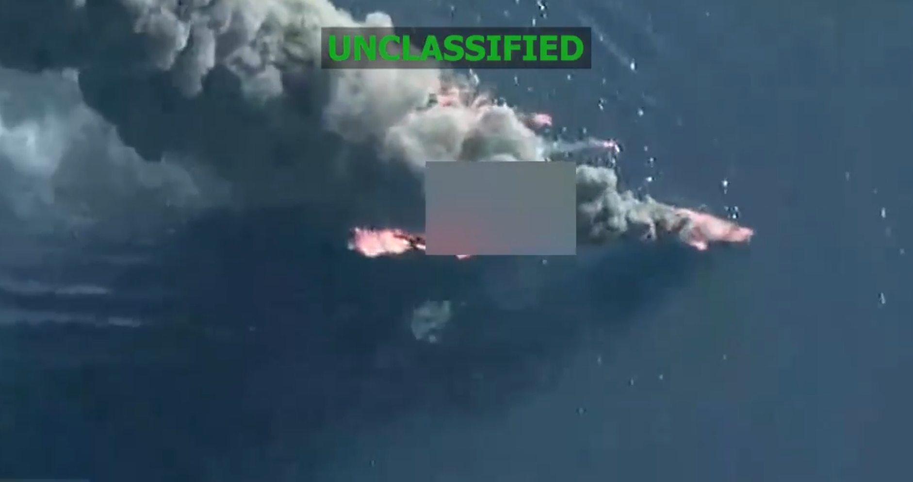 Aerial footage showing smoke and fire burning on top of the sea.