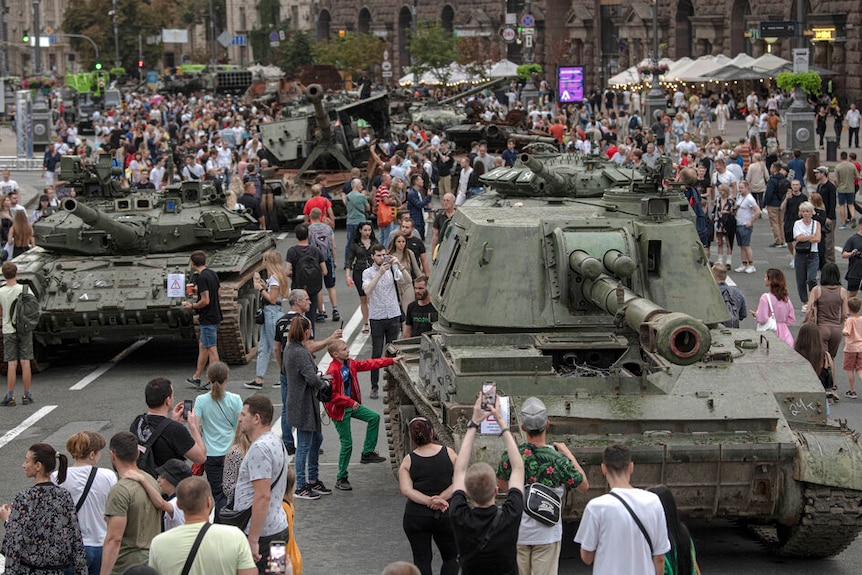 Ukrainians visit an avenue, where destroyed Russian military vehicles have been displayed.