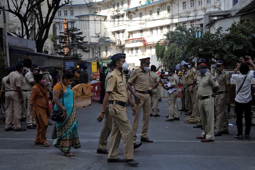 Police mill outside hospital where Lata Mangeshkar passed away, Mumbai, India, February 6, 2022.