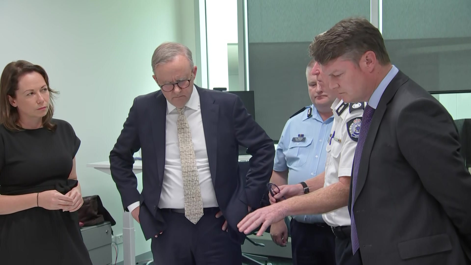 Anthony Albanese stands with Victorian government ministers and authorities in a room