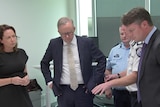 Anthony Albanese stands with Victorian government ministers and authorities in a room