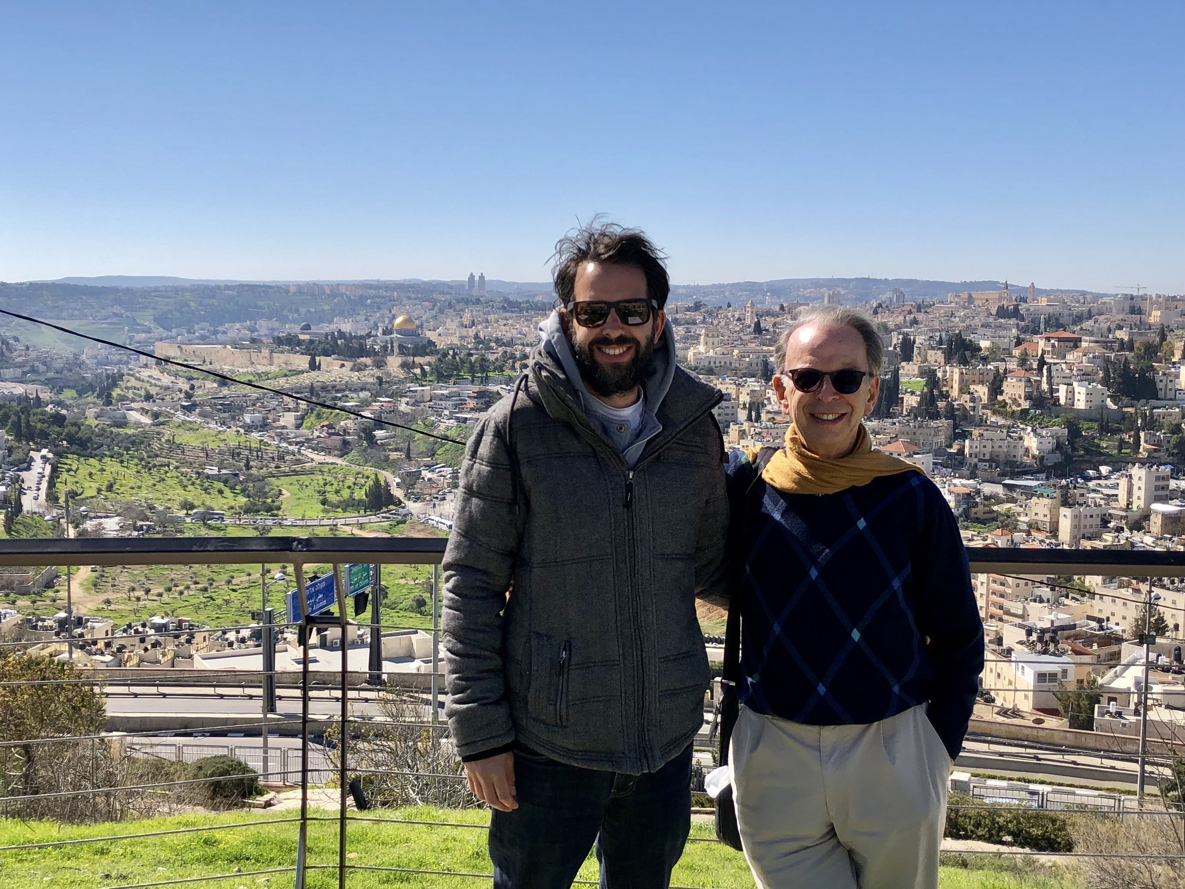Jeff and Antony Loewenstein standing outdoors wearing sunglasses dressed for winter view behind in Westbank