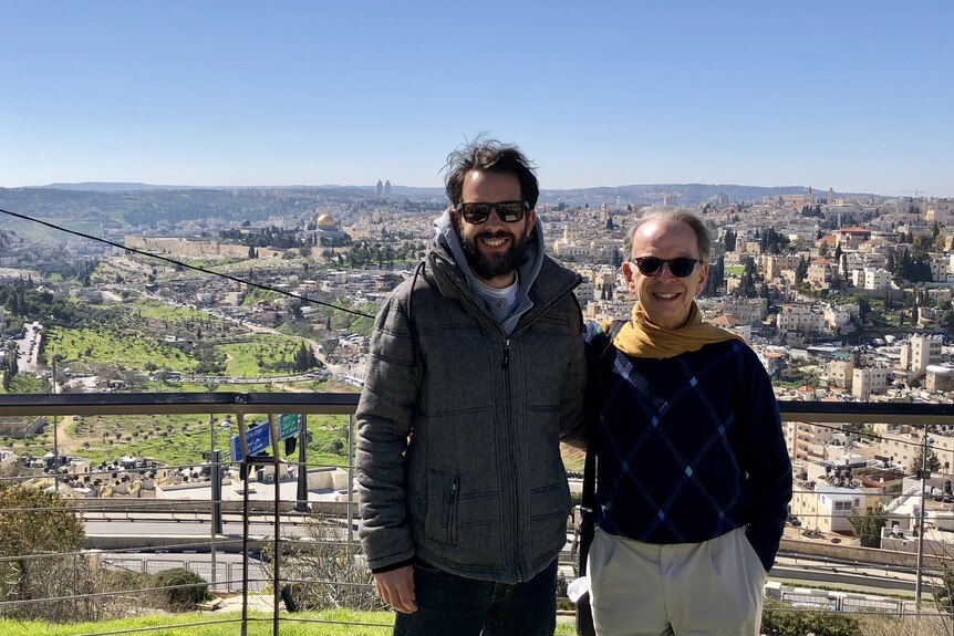 Jeff and Antony Loewenstein standing outdoors wearing sunglasses dressed for winter view behind in Westbank
