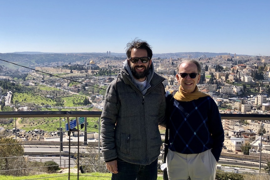 Jeff and Antony Loewenstein standing outdoors wearing sunglasses dressed for winter view behind in Westbank