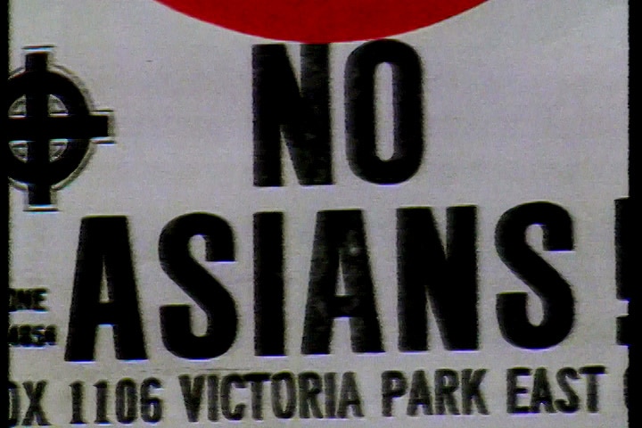 A close-up of a racist poster with anti-Asian messaging.