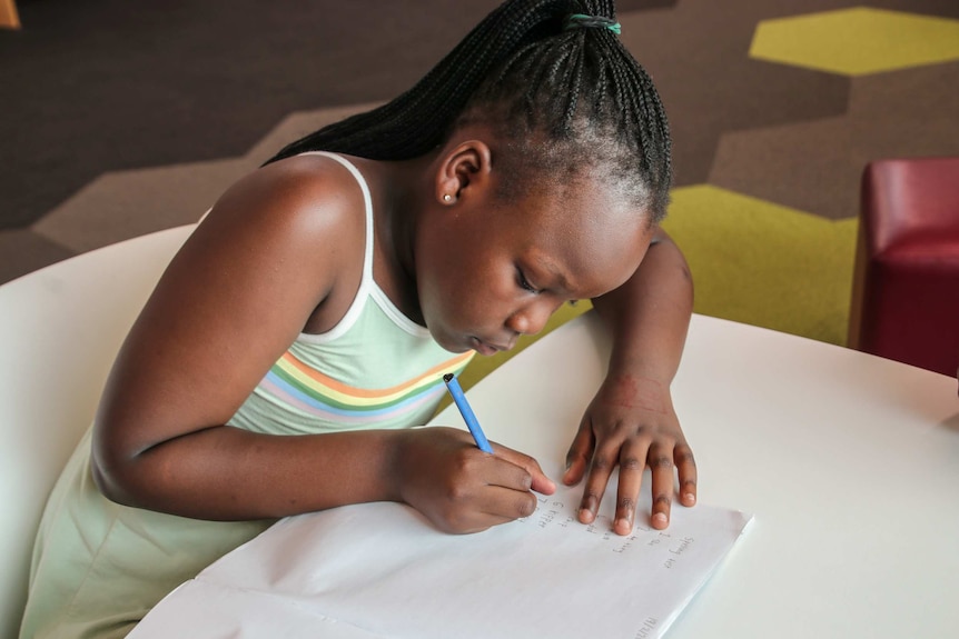 Girl working on schoolwork at desk