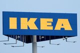An Ikea sign in front of a blue sky.