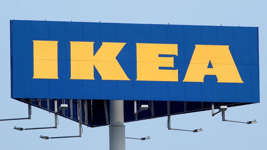 An Ikea sign in front of a blue sky.
