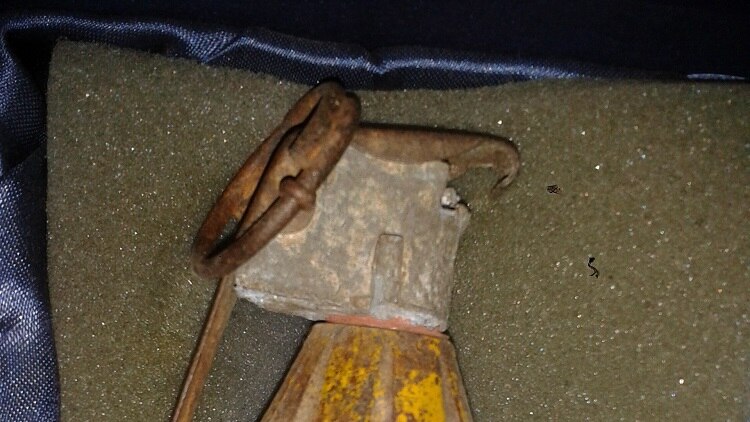 an old rusty grenade with pin