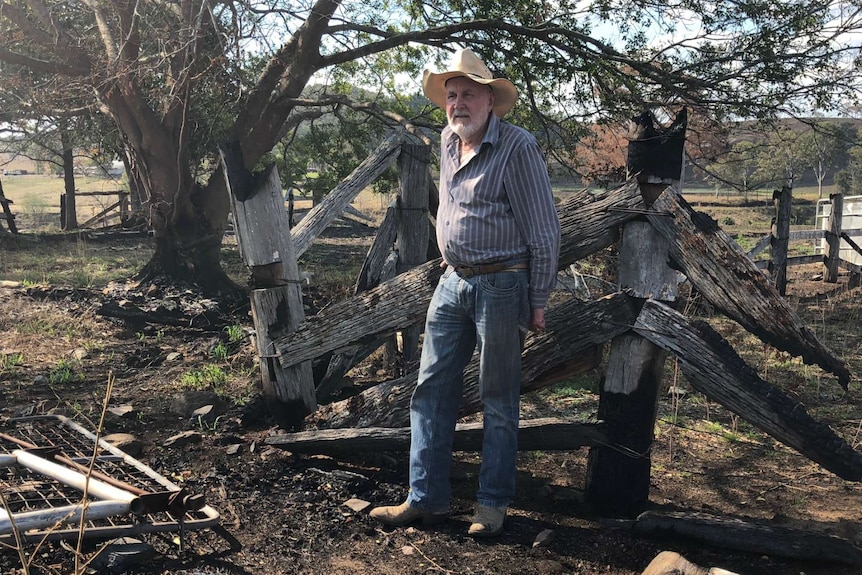 Terry Rauchle stands by the ruins of his yards.