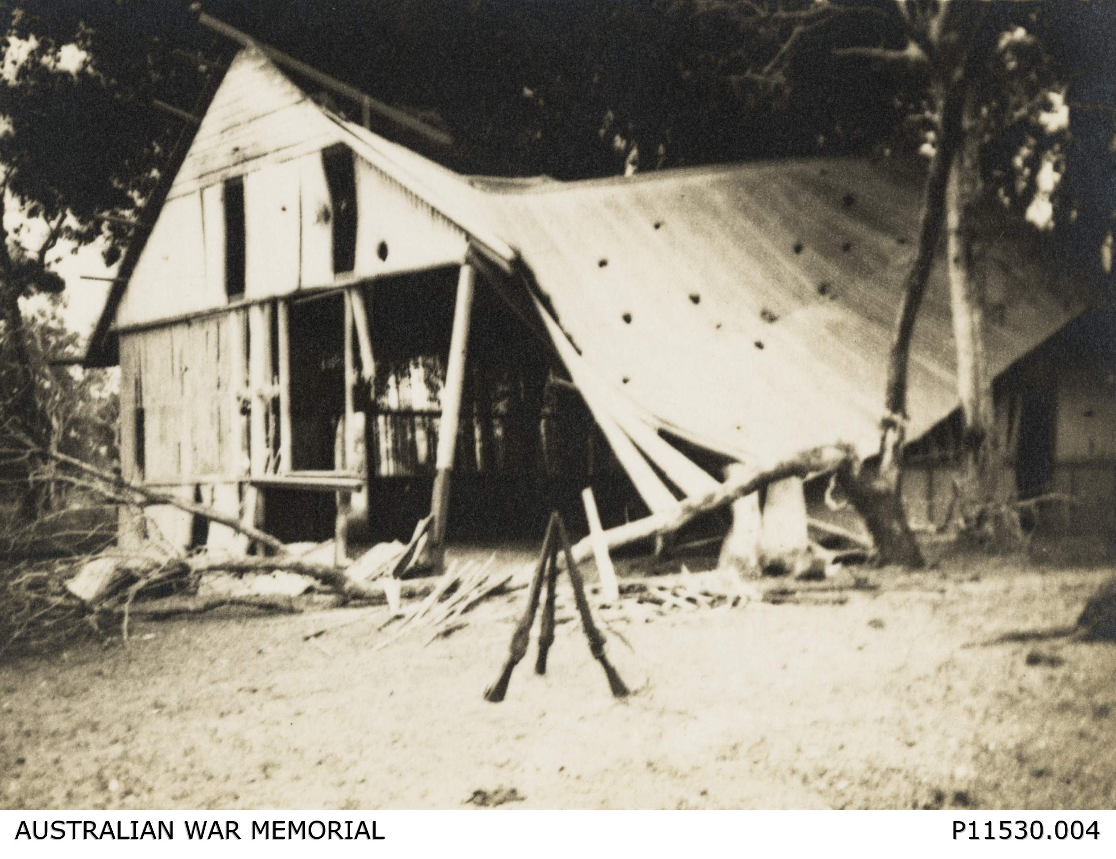 A historical, black and white photo showing the wreckage of a bombed house in Darwin. 