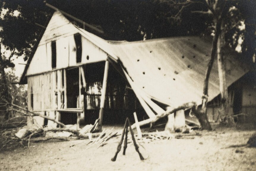 A historical, black and white photo showing the wreckage of a bombed house in Darwin. 