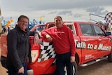 Two men standing in front of a red ute at a field day in Western Australia